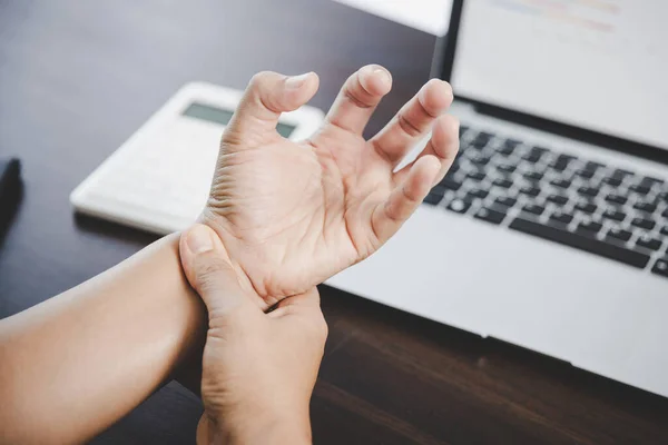 Arthritis person, finger woman ache from working in office. Concept office syndrome hand pain from occupational disease, woman having wrist pain from using laptop computer, wrist pain.