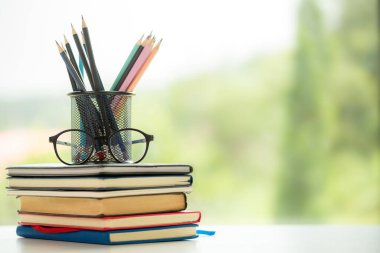 Object education green nature background with stack of ancient books or old bible, open paper book on wooden table with copy space. concept of back to school, research study