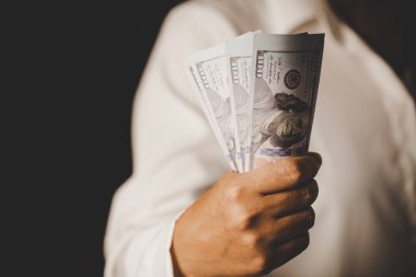 Banknote of 100 dollar bills in hands of rich woman person. Success business female holding cash money for investment. concept of saving finance, exchange bank, american currency, salary payment