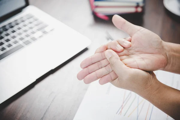 Arthritis person, finger woman ache from working in office. Concept office syndrome hand pain from occupational disease, woman having wrist pain from using laptop computer, wrist pain.