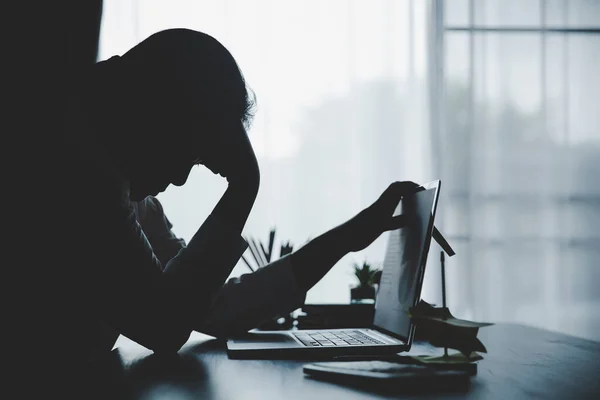 Stress business woman person from hard work, depression in office. Tired and anxious employee female with unhappy at problem job. young businesswoman sitting sad front of laptop computer on desk.