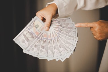 Banknote of 100 dollar bills in hands of rich woman person. Success business female holding cash money for investment. concept of saving finance, exchange bank, american currency, salary payment