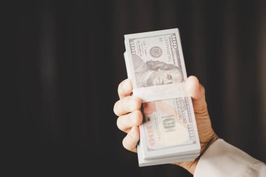 Banknote of 100 dollar bills in hands of rich woman person. Success business female holding cash money for investment. concept of saving finance, exchange bank, american currency, salary payment