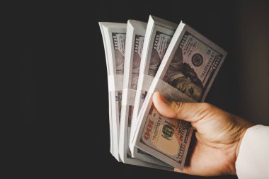 Banknote of 100 dollar bills in hands of rich woman person. Success business female holding cash money for investment. concept of saving finance, exchange bank, american currency, salary payment