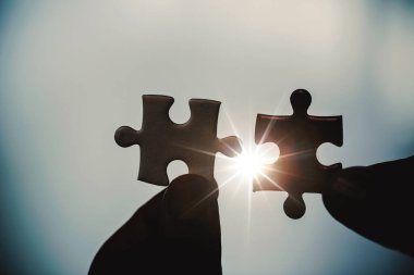Business woman person hand holding puzzle piece idea for strategy and solution. Closeup part of two white jigsaw connect together. Concept of join cooperation success teamwork-problem corporate team