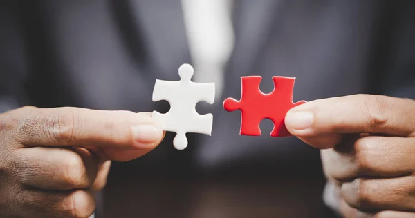 Business woman person hand holding puzzle piece idea for strategy and solution. Closeup part of two white jigsaw connect together. Concept of join cooperation success teamwork-problem corporate team
