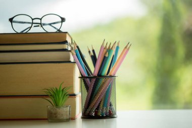 Object education green nature background with stack of ancient books or old bible, open paper book on wooden table with copy space. concept of back to school, research study