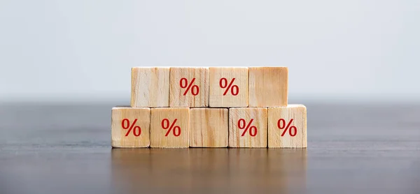 Closeup wood cubes with percentage symbol, business interest, discount investment, financial growth, interest rate increase, sale price and tax rise, future gain, market digital concept