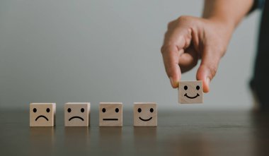 Memnuniyet araştırması konsepti. Müşteri hizmetleri en iyi iş derecelendirme deneyimi. İş kolu tahta blok çemberinde gülen bir yüz seçiyor. 5 Yıldız Memnuniyeti. İnsanlar kendilerini harika hissediyorlar..