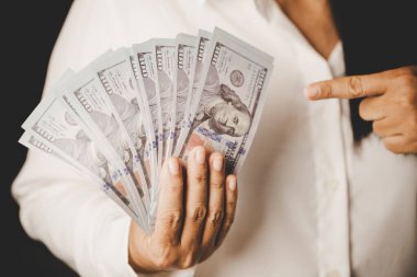 Banknote of 100 dollar bills in hands of rich woman person. Success business female holding cash money for investment. concept of saving finance, exchange bank, american currency, salary payment