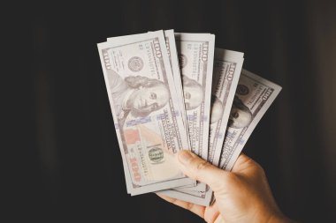 Banknote of 100 dollar bills in hands of rich woman person. Success business female holding cash money for investment. concept of saving finance, exchange bank, american currency, salary payment