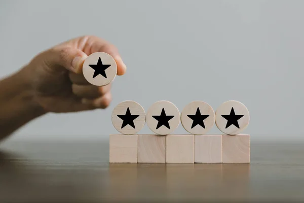 Satisfaction survey concept. Customer services best excellent business rating experience. Hand of business chooses a smile face on wood block circle. 5 Star Satisfaction. People feel great product.