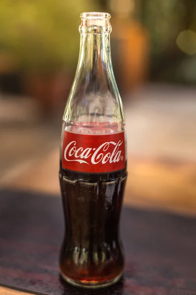 coca-cola glass soda bottle beverage with blurred background