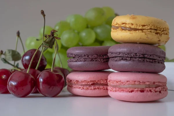Close Appetizing Mix Macarons Cherries Light Grey Background Blurred Plate — Zdjęcie stockowe