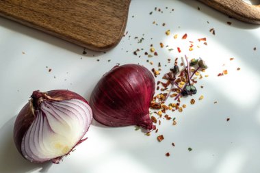 Güneşli bir yaz gününde, beyaz bir masada, kırmızı bir onio 'nun iki yarısı