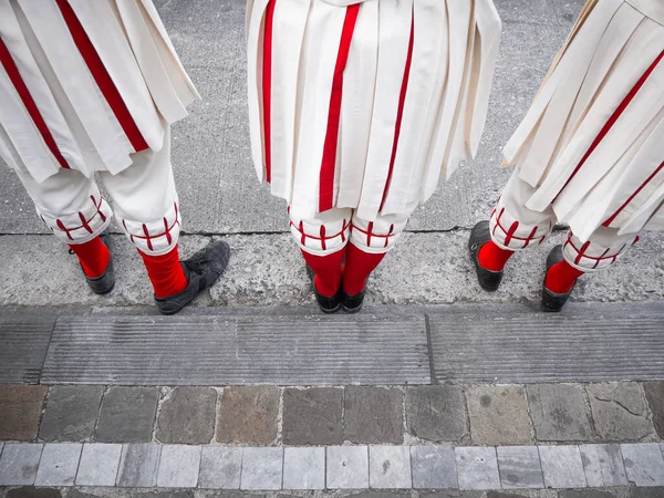 Feet of some participants in costume during the traditional Ommegang ceremony in front of the Church of Lady of the Sablon in Brussels, Belgium.