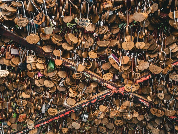 Close shot of lovers' padlocks (love locks) on a bridge over the Seine River in Paris, France.