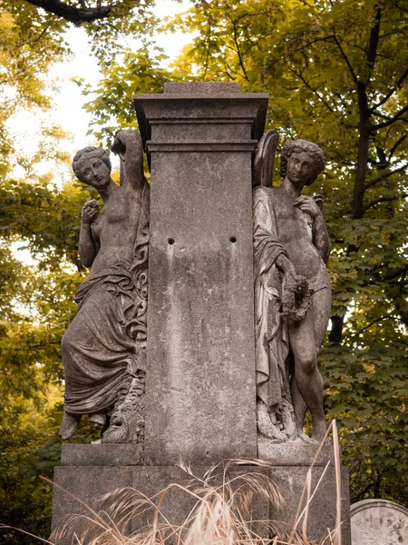 Sculptures of two women in the famous Pere Lachaise cemetery in Paris, France. The cemetery is a tourist destination since many famous people sleep there.