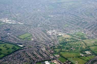 Aerial view looking South across the London Borough of Sutton with the North East Surrey Crematorium towards the bottom of the image and Merton, Morden and Sutton beyond.  Sunny spring morning.