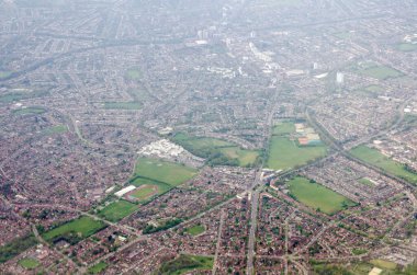 Aerial view looking South across the London Borough of Sutton with the landmark St Helier Hospital in the middle of the image surrounded by housing in the suburb of Carshalton on a sunny spring morning. The David Weir Leisure Centre is towards the lo
