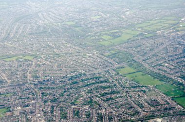 View from the air looking South from the Berrylands district of Kingston-Upon-Thames towards Tolworth, Elmbridge and New Malden.  The Green Lanes Recreation Ground is in the bottom right corner and the A3 road cuts diagonally through the image.