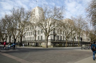 London, UK - March 21, 2022: View from Montague Place looking towards the imposing headquarters of the University of London  - Senate House in Bloomsbury.  Pedestrians are walking in the sunshine of this sunny Spring day.