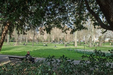 London, UK - March 21, 2022: Londoners enjoying the sunshine at Russell Square on a Spring afternoon in Bloomsbury, London.  