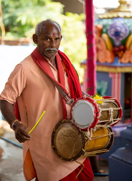 Man using Dholak drums in a temple at Nellore, Andhra pradesh, India, 01 Aug 2022