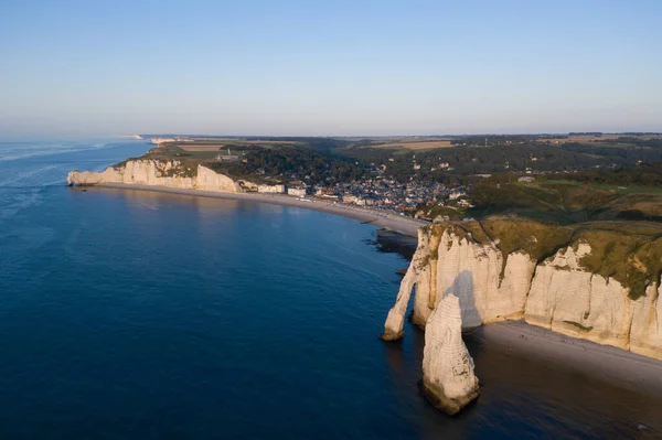 Aerial view of the coastal cliffs of Etretat at sunset in Normandy in France. Europe landscapes from a drone and panorama