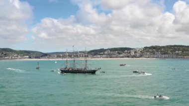 Aerial view of the Belem - a French three-masted sailing ship leaving the port of Fcamp during the Grand'Escale event - Sailing boat in front of the cliffs of Normandy and the town of Fcamp