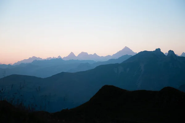 First sunlight on the mountains of the Lac de Peyre in French Alps. Mountain layers at sunrise