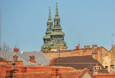 Amazing Romania - The two towers of the orthodox church behind rooftops, from Lugoj town