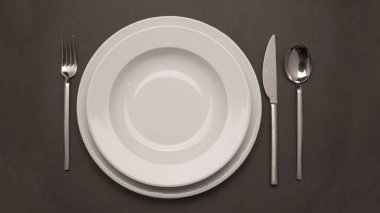 empty plate and fork on a black background
