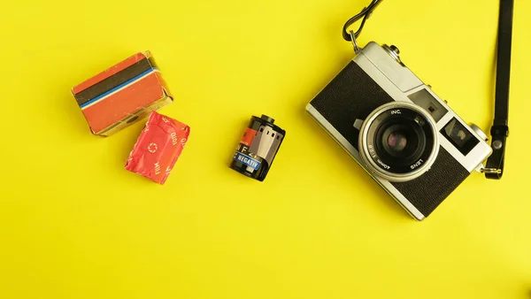travel concept. camera, sunglasses, suitcase, map, binoculars, passport, glasses on yellow background.