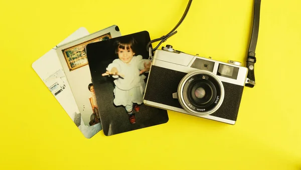 vintage camera with a photo of a retro film cameras on a yellow background