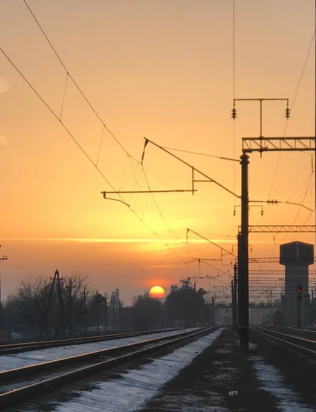 railroad tracks in the evening. sunrise, railway and train station.