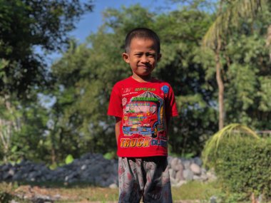 BLITAR, INDONESIA - July 30, 2022: Boys study creative lines to prepare for Indonesian Independence day on Saturday morning with full expression