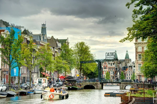 Amsterdam, Netherlands - August 2021: Historical center in cloudy weather, HDR Image