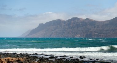 Caleta de Famara, Lanzarote - September 2020 : Picturesque seaside village in sunny weather, HDR Image