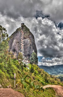 Guatape, Colombia - May 2019 : Rock of Guatape in cloudy weather