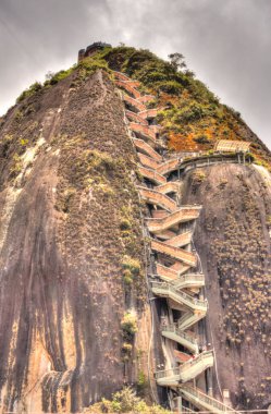 Guatape, Colombia - May 2019 : Rock of Guatape in cloudy weather