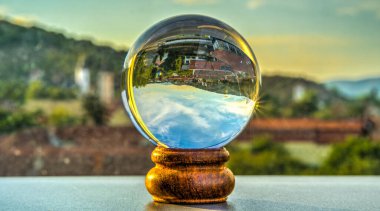 glass globe with a ball on the background of the sea.
