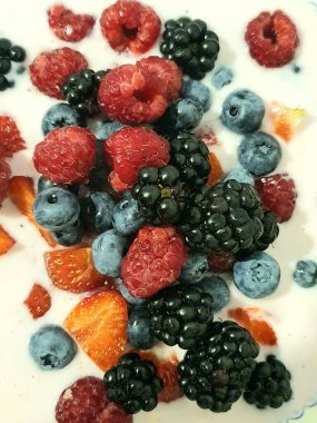 fresh berries and blueberries on a yogurt