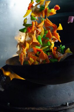 Flamed wok in the kitchen