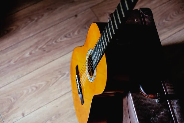 Spanish guitar close up with vintage suitcase