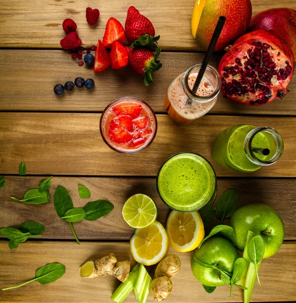 Fresh prepared fruit juices photographed from above on wood background