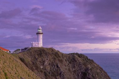 a wide angle view of the historic lighthouse at sunrise on a spring morning at byron bay in northern nsw, australia