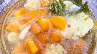 delicious chicken noodle soup in a pot on a plate