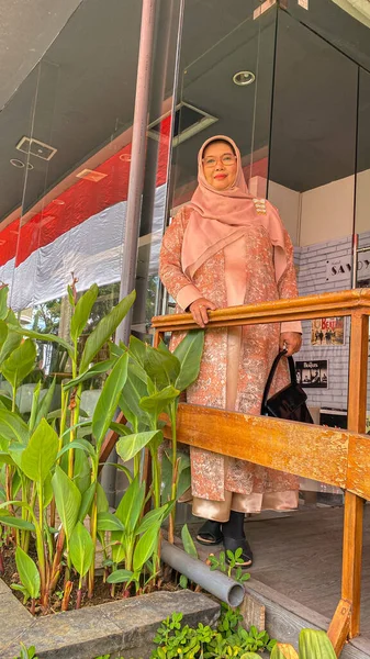 young beautiful woman wearing indonesian kebaya hijab and smiling, looking to camera with smile on face