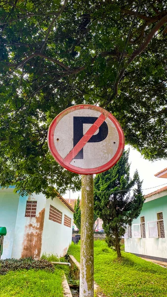 a pedestrian no parking sign of a road signs on a sunny day in the background.
